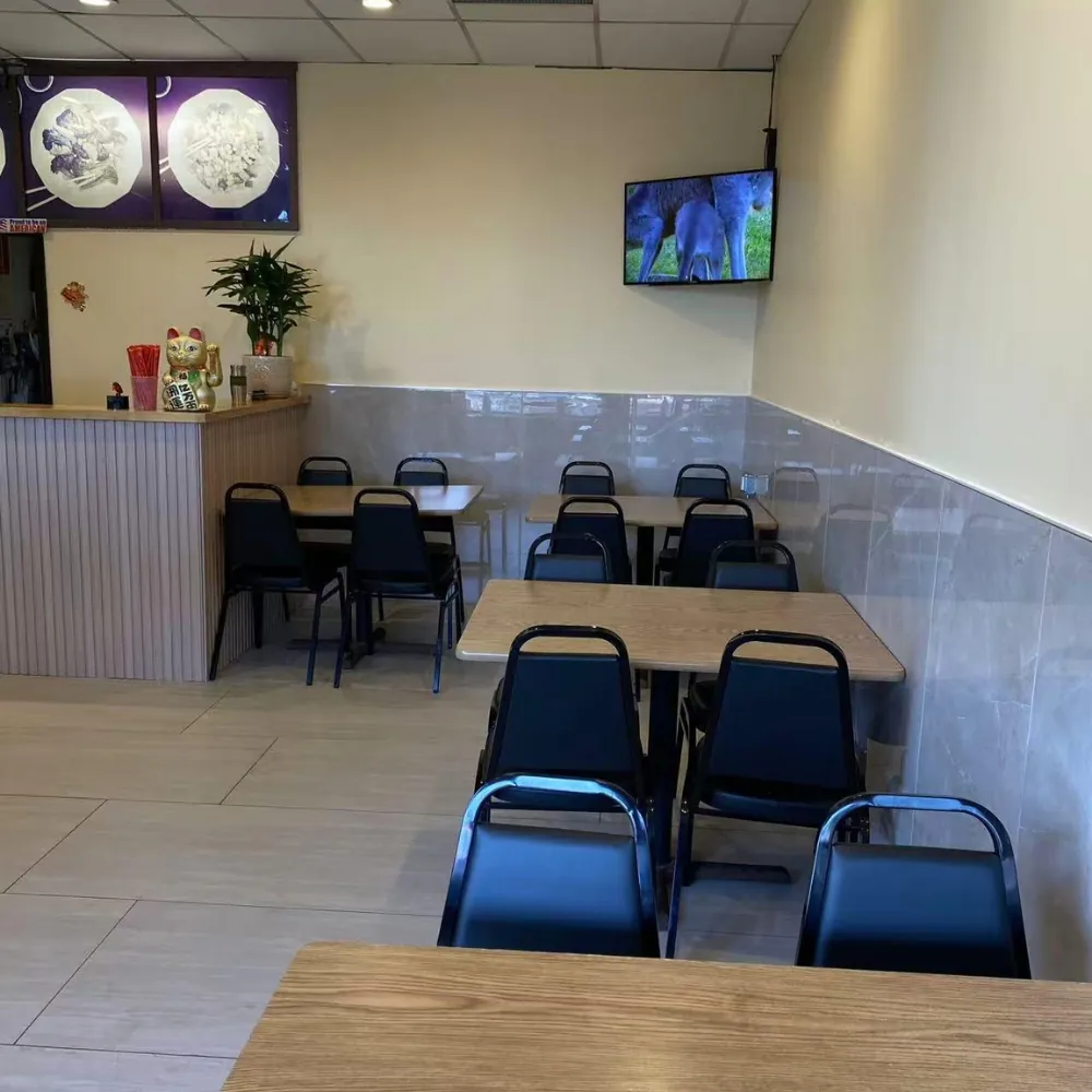 Tidy seating space with tables, chairs and a TV at Oriental Chinese Restaurant, a Chinese Restaurant in Woburn